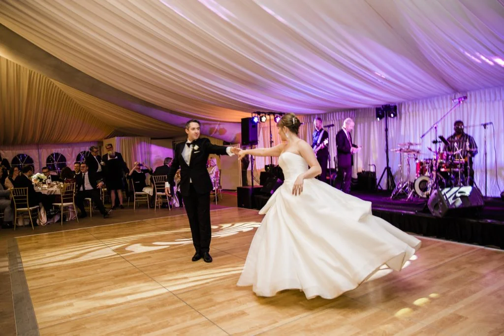 bride and groom on dance floor in tent wedding 