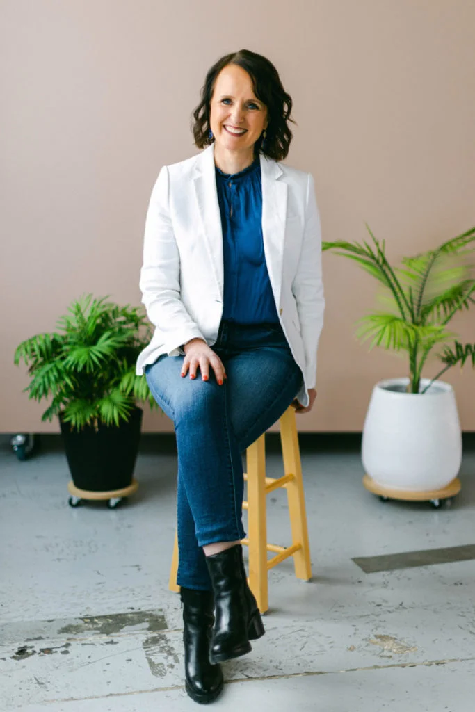 wedding planner with white jacket on blue sofa