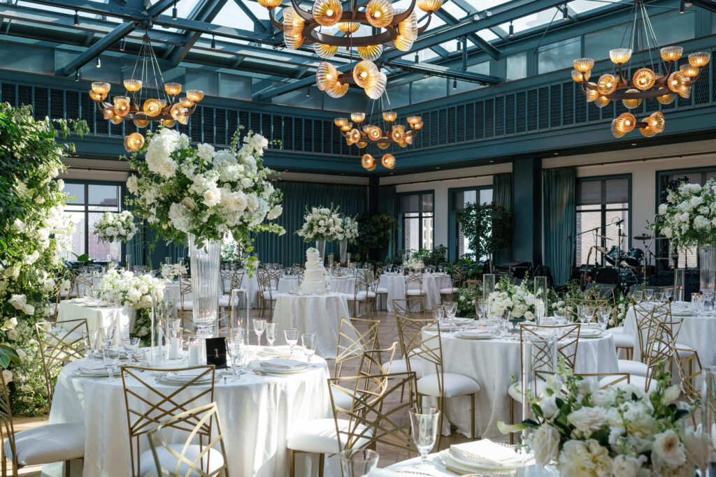 Outdoor wedding ceremony at a Michigan venue surrounded by greenery and guests